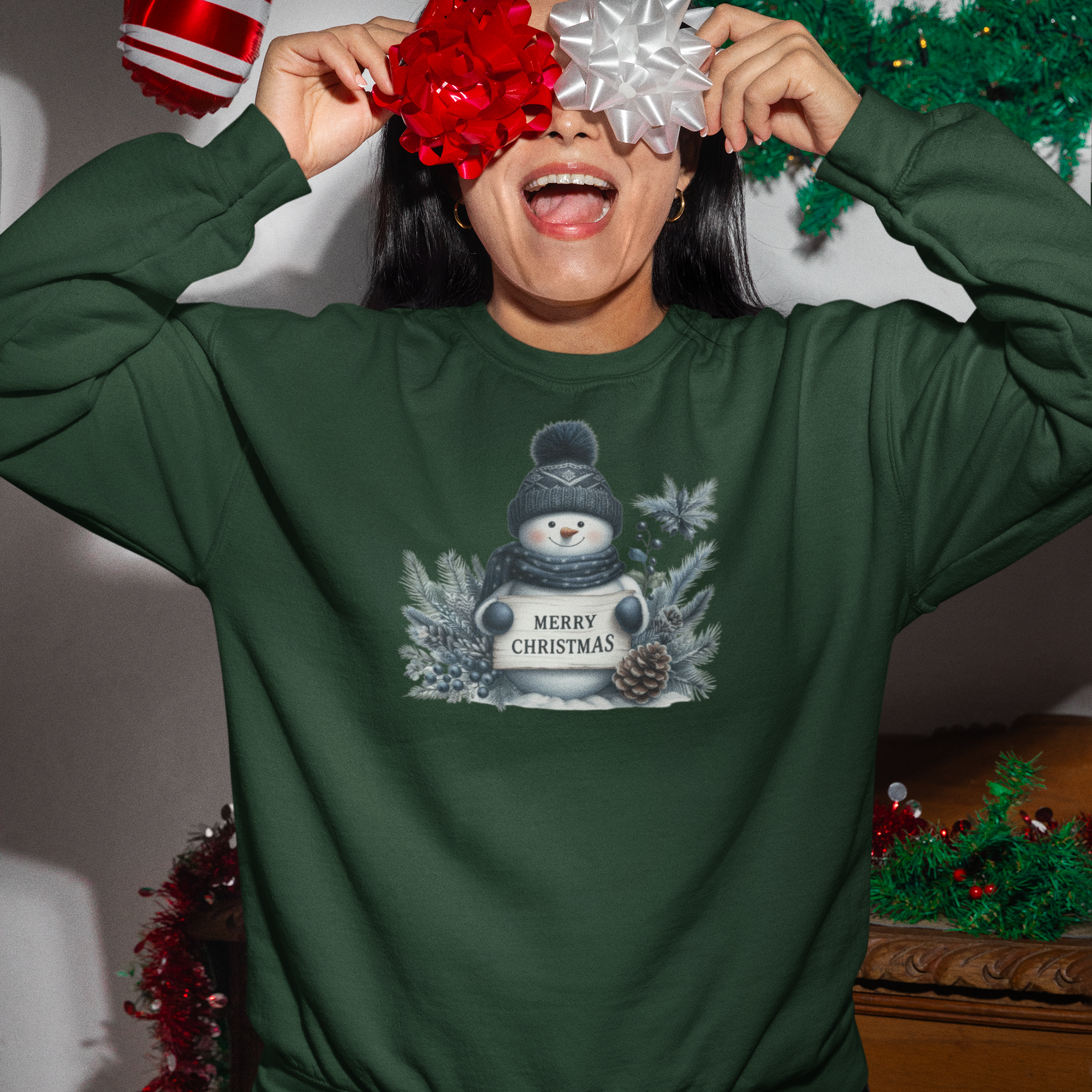 Person wearing a green Christmas-themed sweatshirt with festive decorations in the background.