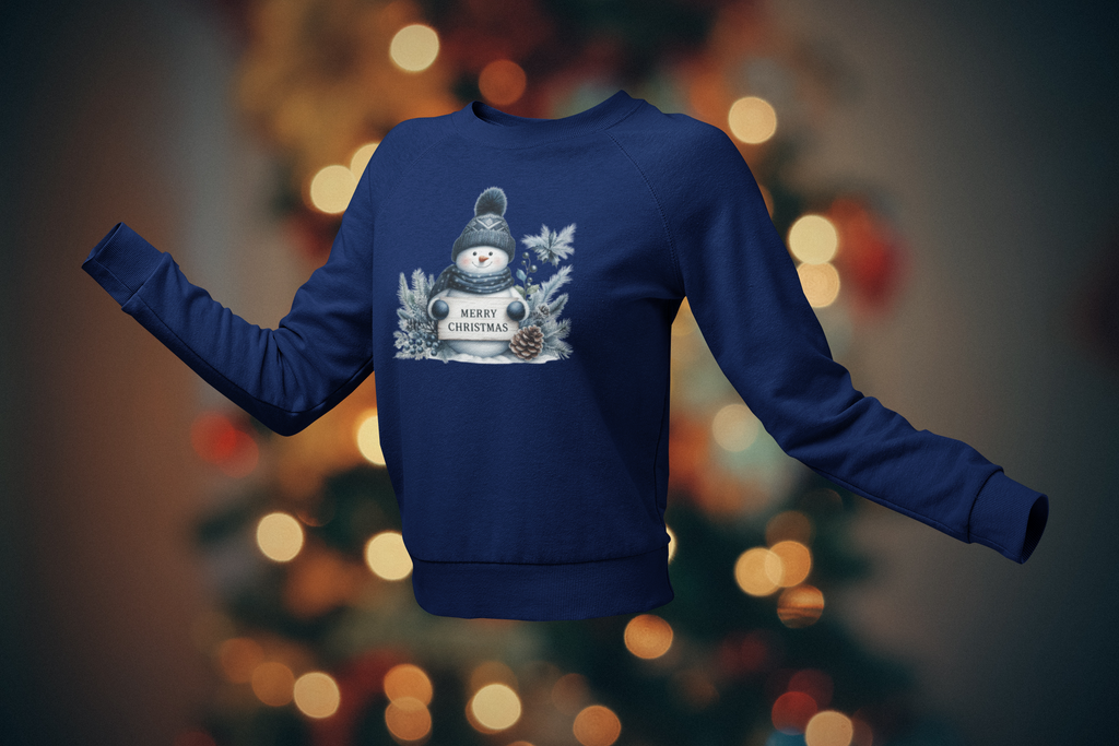 Blue sweatshirt with a snowman design on a blurred Christmas tree background