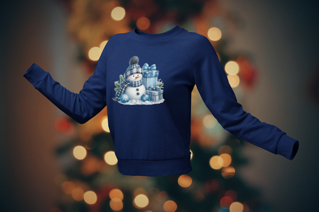Blue sweatshirt with a snowman design on a blurred Christmas tree background