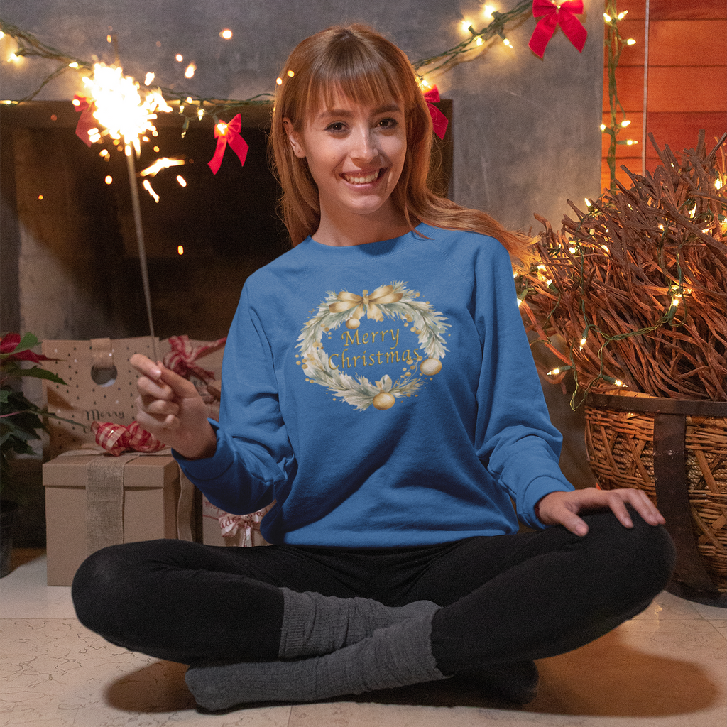 Woman in a blue sweater with a Christmas design, sitting in front of a decorated fireplace.