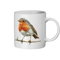 White mug with a robin design on a white background