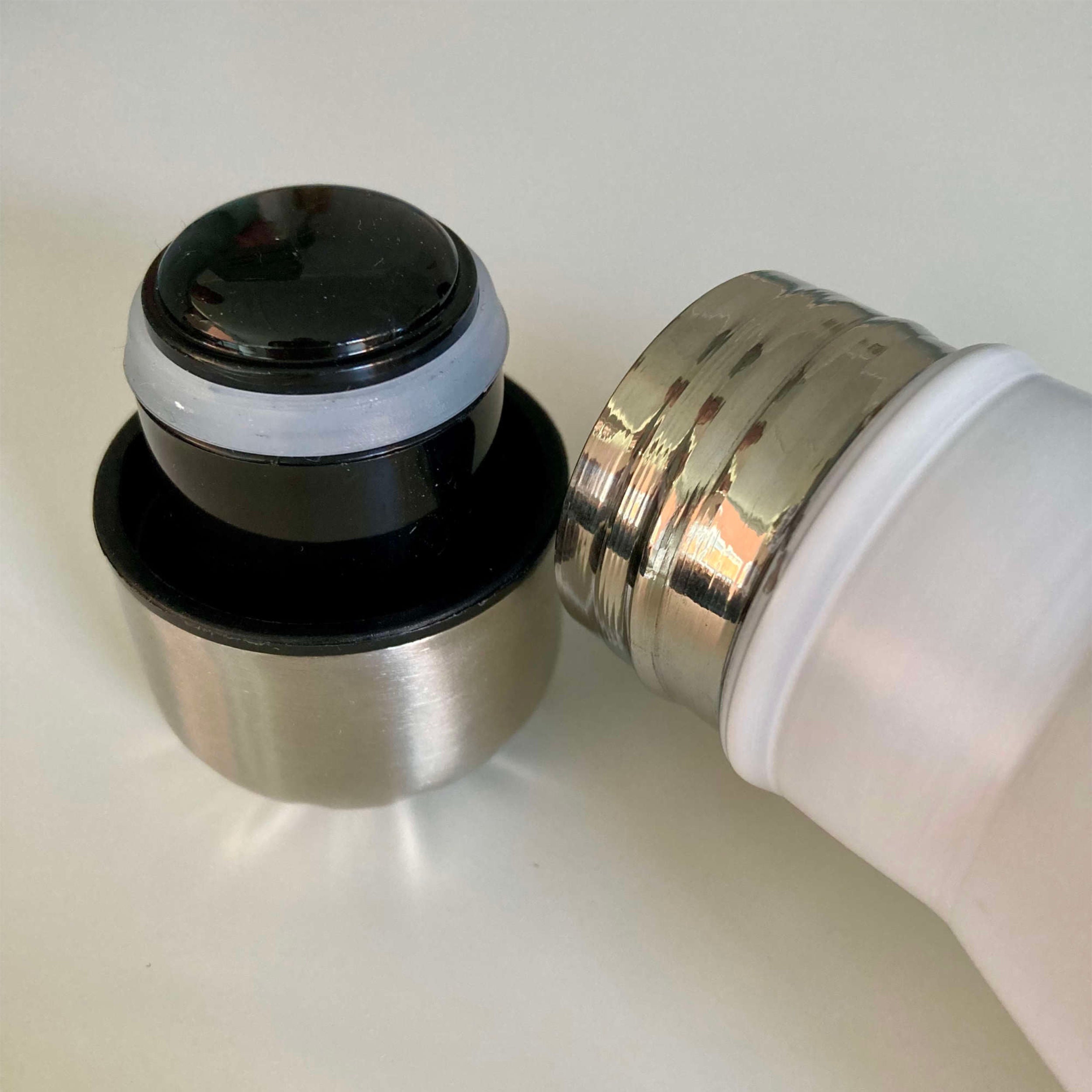 Close-up of a black and silver light bulb socket on a white background