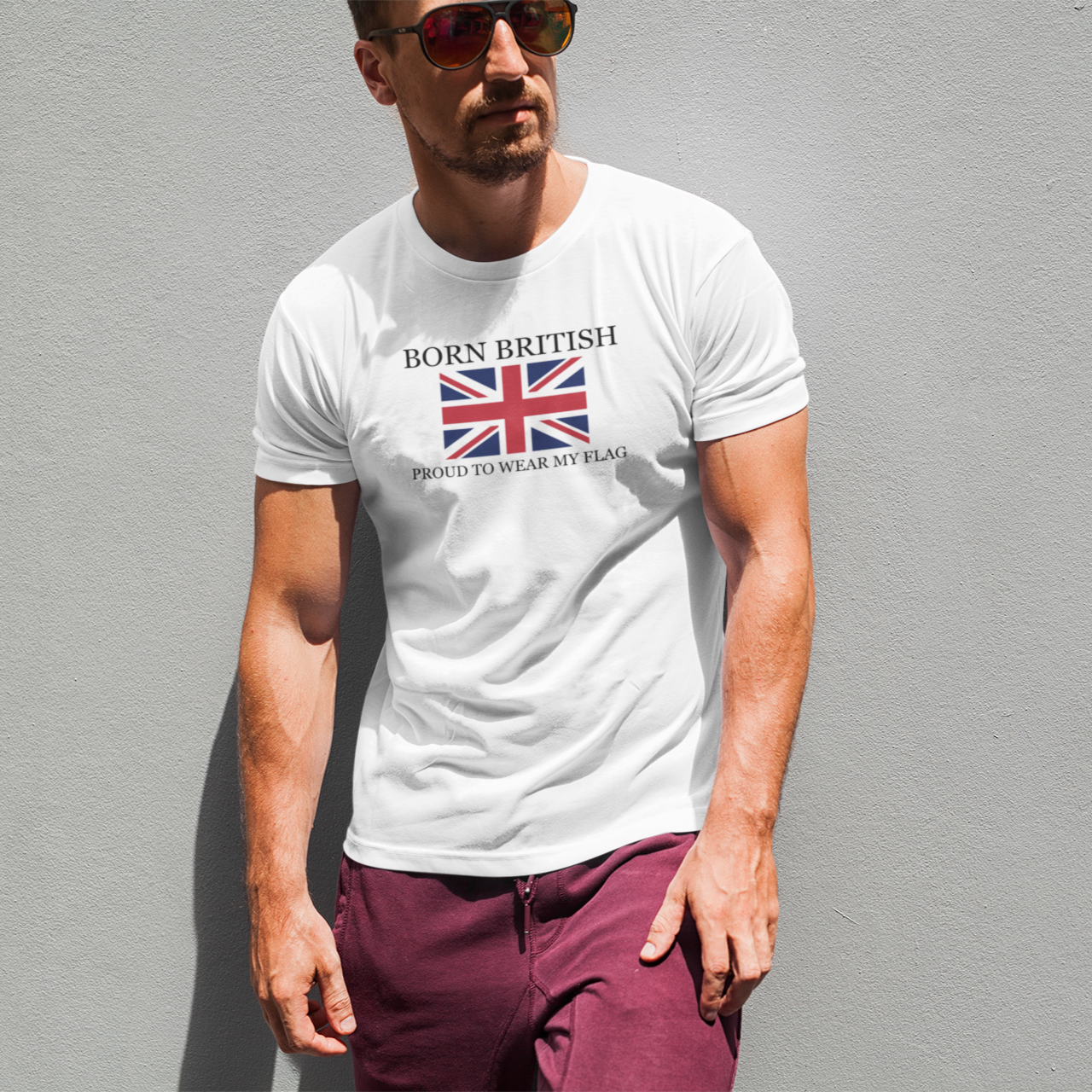 Man wearing a white t-shirt with a British flag design and text against a gray background