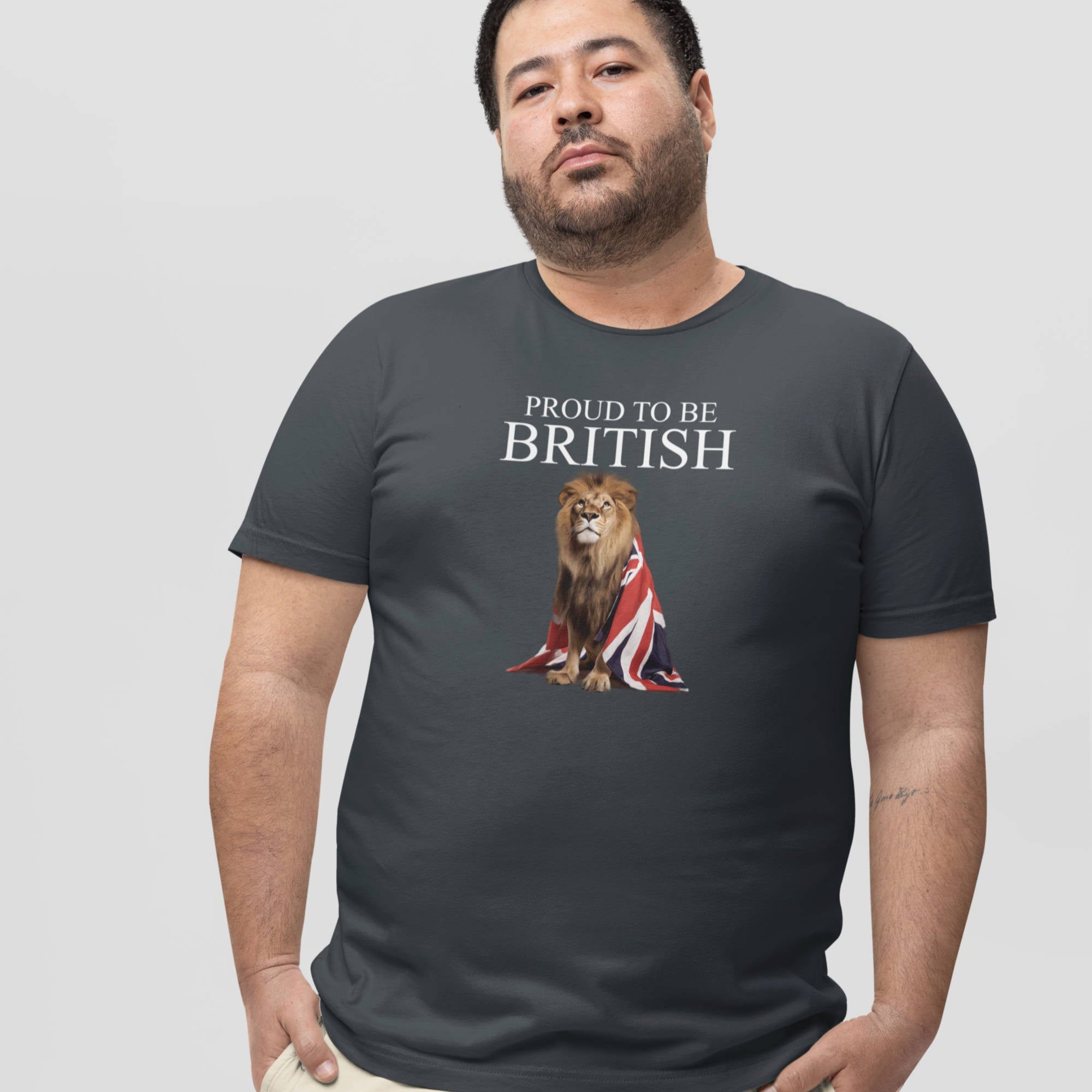 Man wearing a black t-shirt with a lion and Union Jack design, text 'Proud to be British' on a light gray background