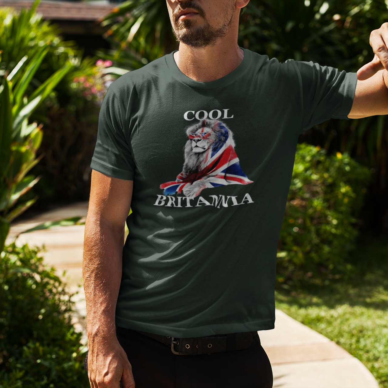 Man wearing a t-shirt with a lion and Union Jack design outdoors.
