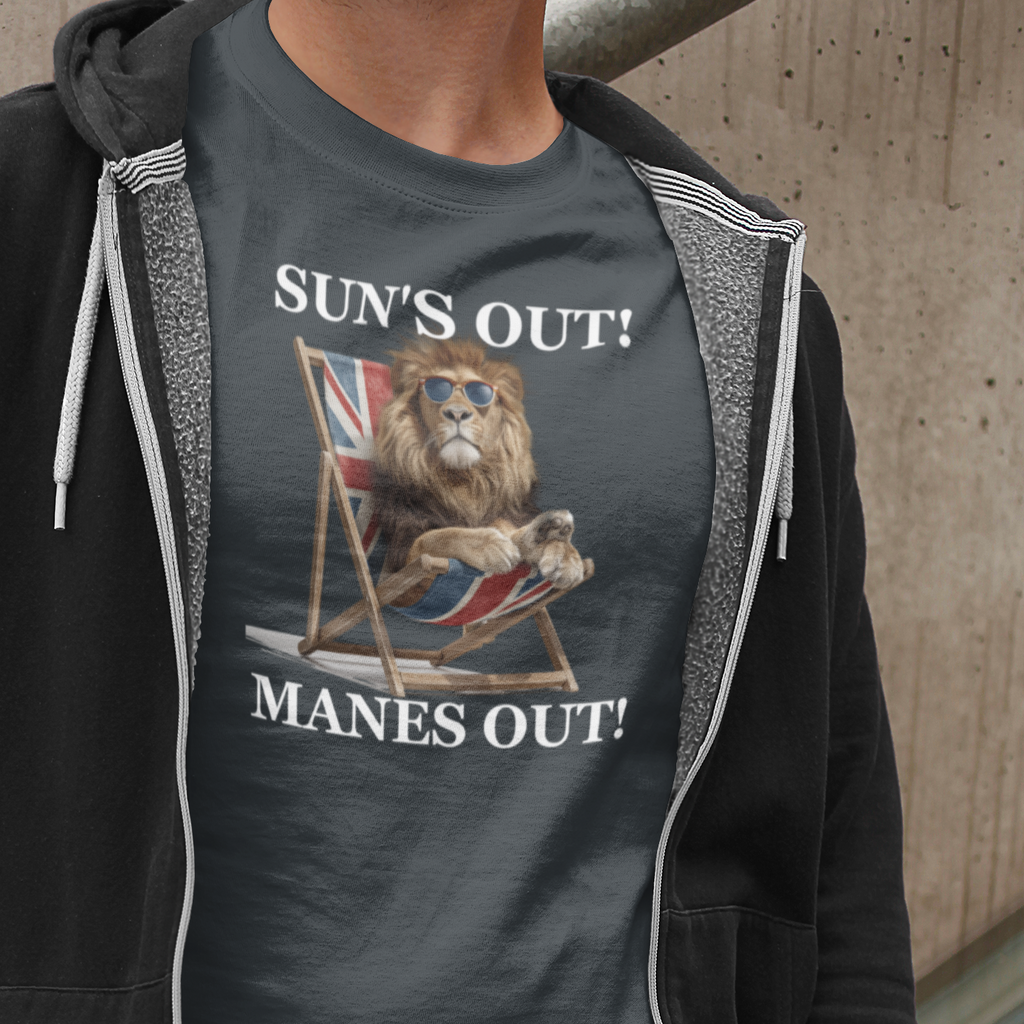 Person wearing a t-shirt with a graphic design and text 'SUN'S OUT! MANES OUT!' against a concrete wall.