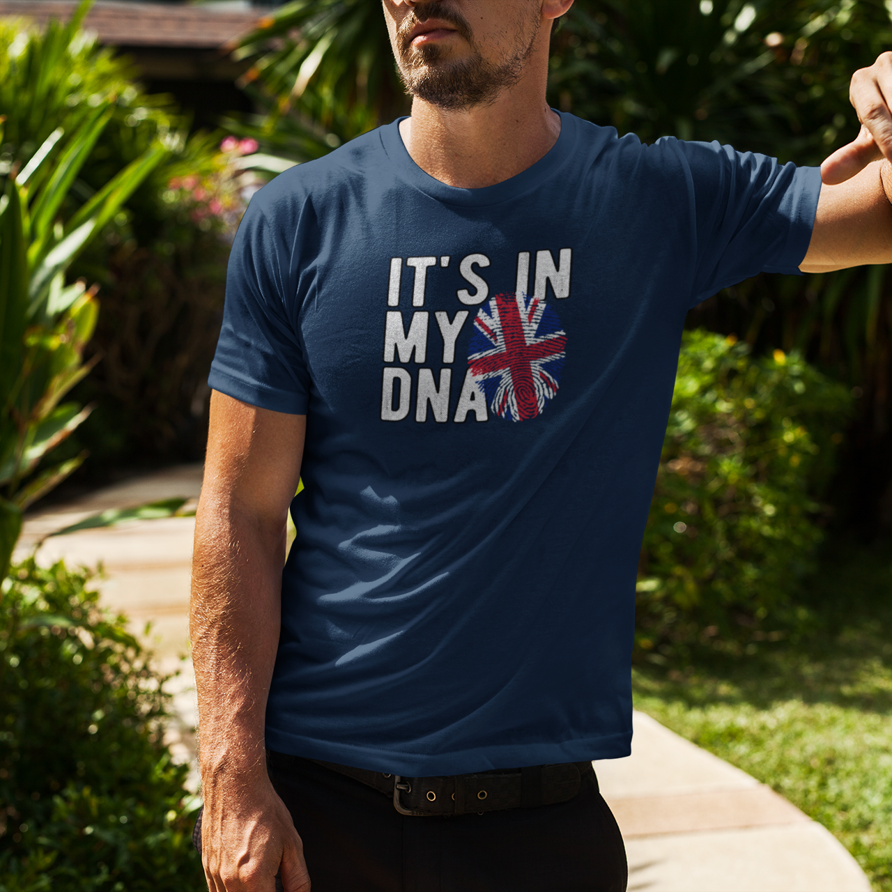 Man wearing a blue t-shirt with a British flag design outdoors.