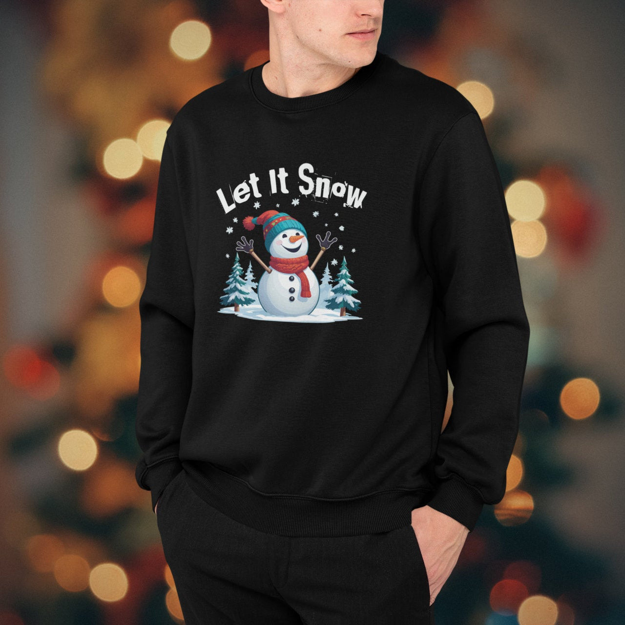 Person wearing a black sweatshirt with a snowman graphic and 'Let it Snow' text against a blurred festive background.