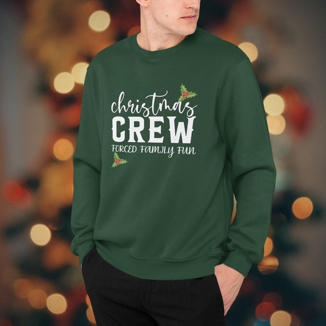 Person wearing a green 'Christmas Crew' sweater with a blurred festive background