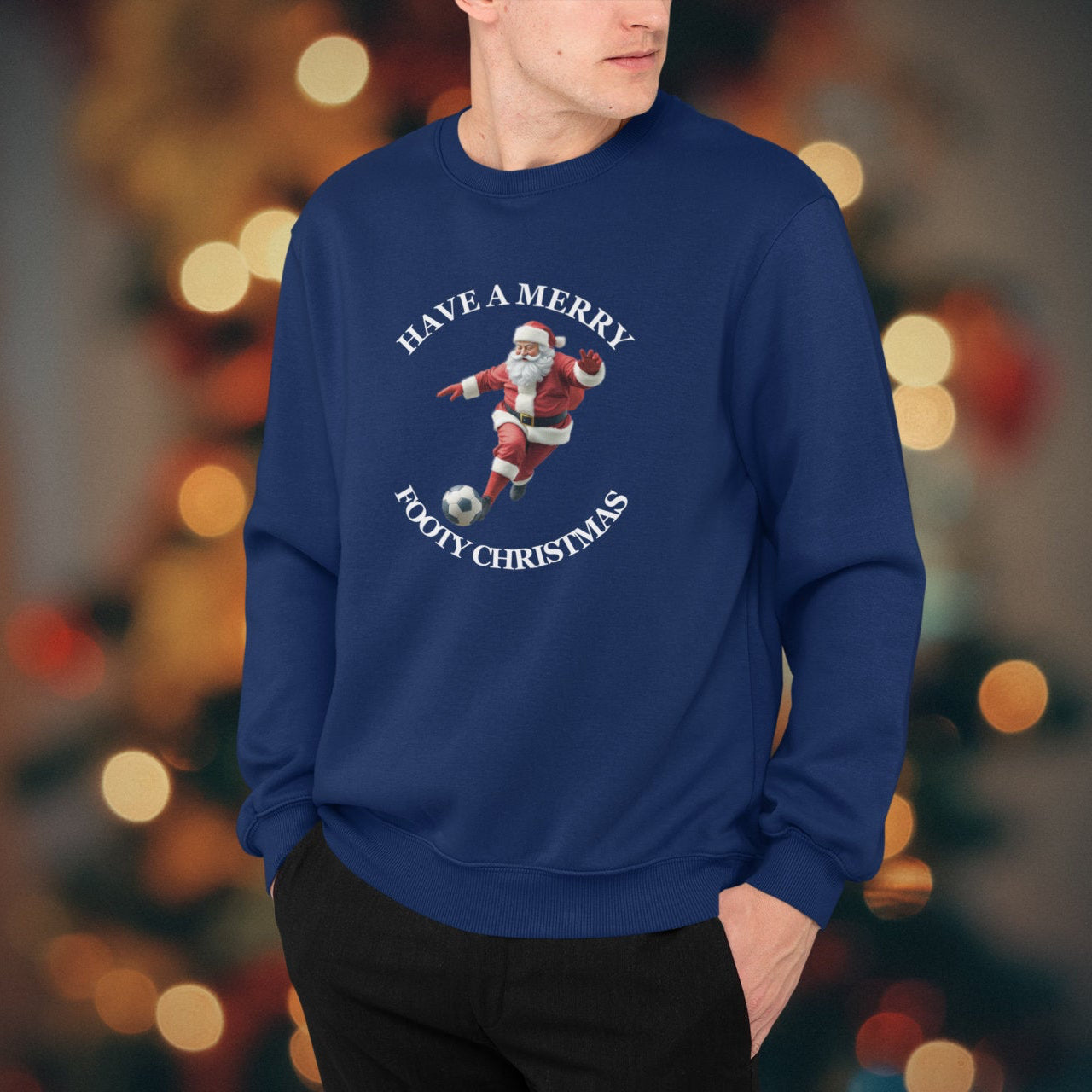 Person wearing a blue sweater with a Christmas design in front of a blurred festive background