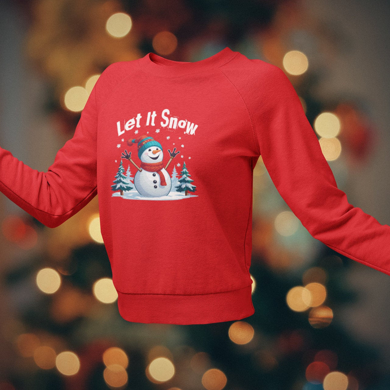 Red sweatshirt with 'Let It Snow' text and snowman graphic on a blurred Christmas tree background