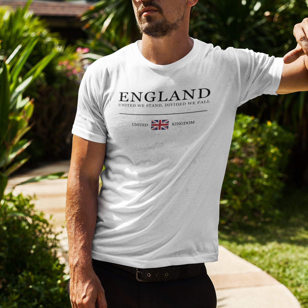 Man wearing a white t-shirt with 'ENGLAND' text and Union Jack design outdoors.