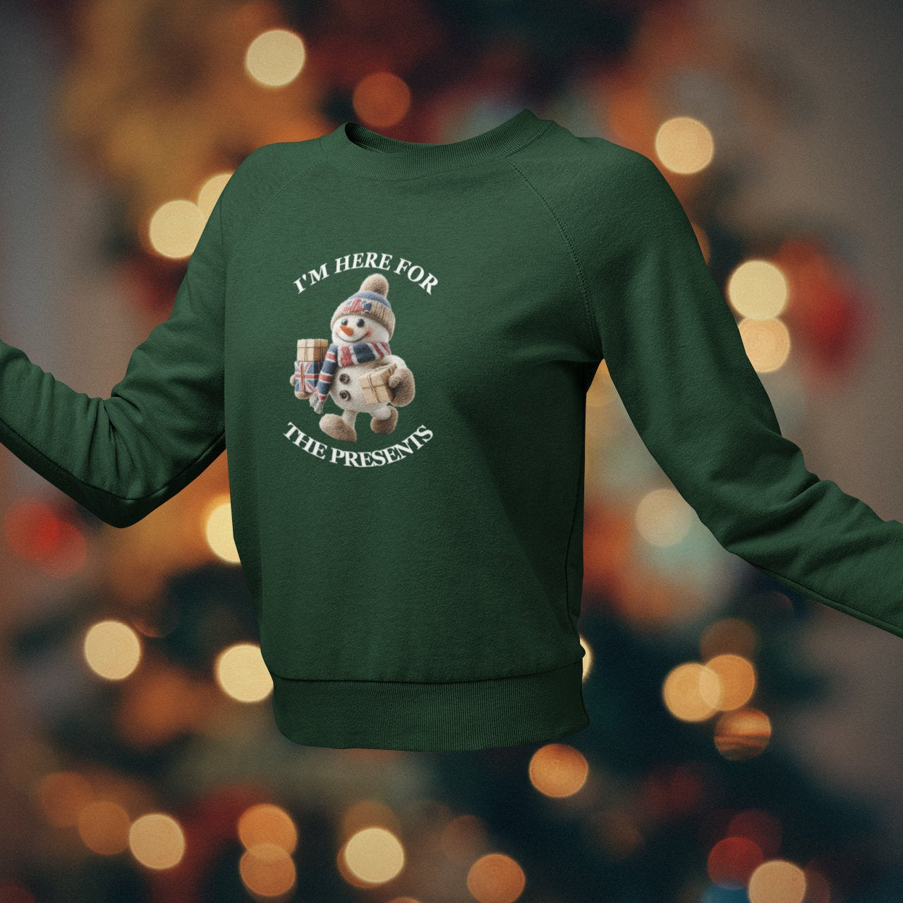 Green sweatshirt with a snowman graphic and text on a blurred bokeh background