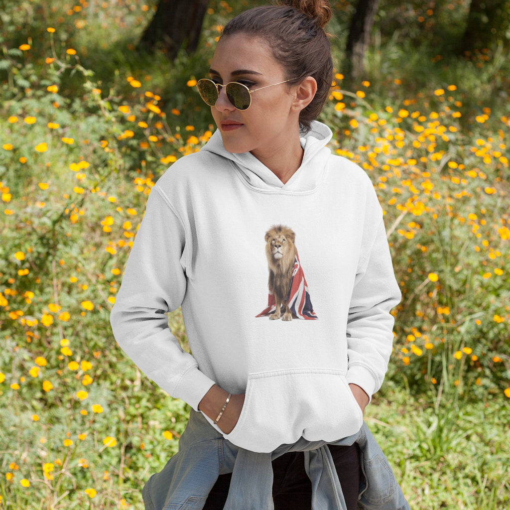 Woman wearing a white hoodie with a lion and Union Jack design, standing in a field of yellow flowers.