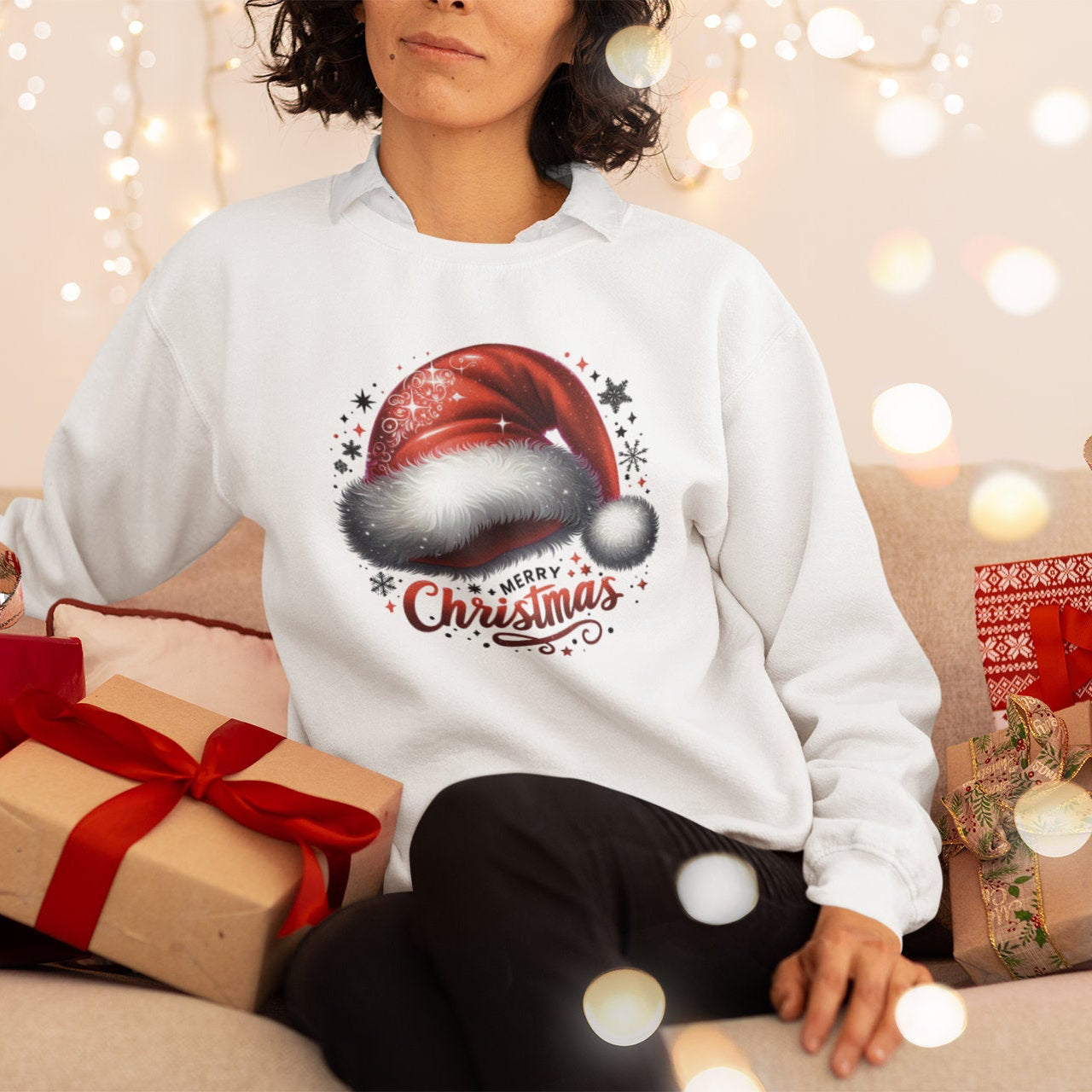 Person wearing a white sweatshirt with a Christmas design, surrounded by festive decorations and gifts.