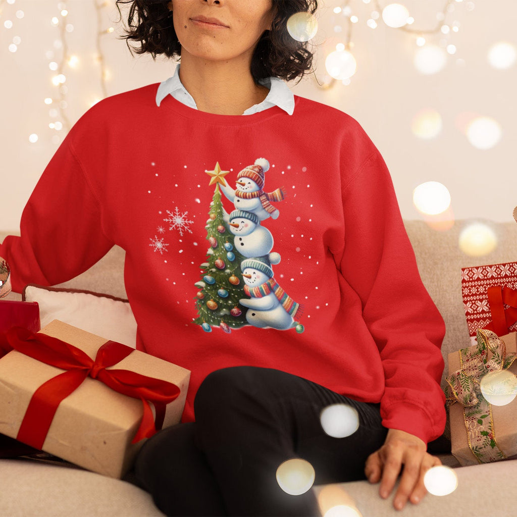 Woman wearing a red Christmas sweater with snowmen and a tree design, surrounded by festive decorations.